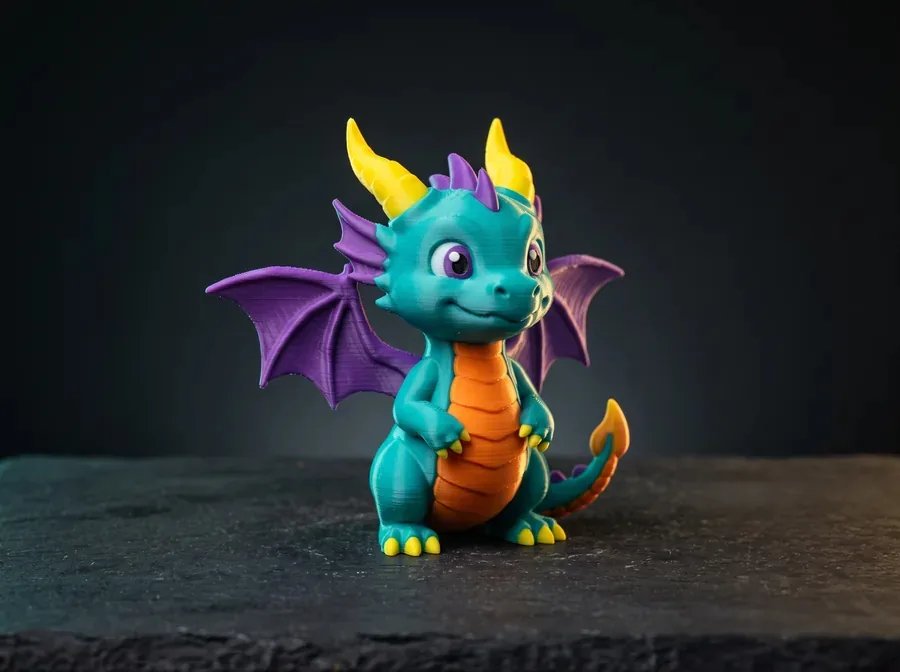 A multi-color 3D-printed dragon figurine — teal, orange, purple, and yellow filaments in one print